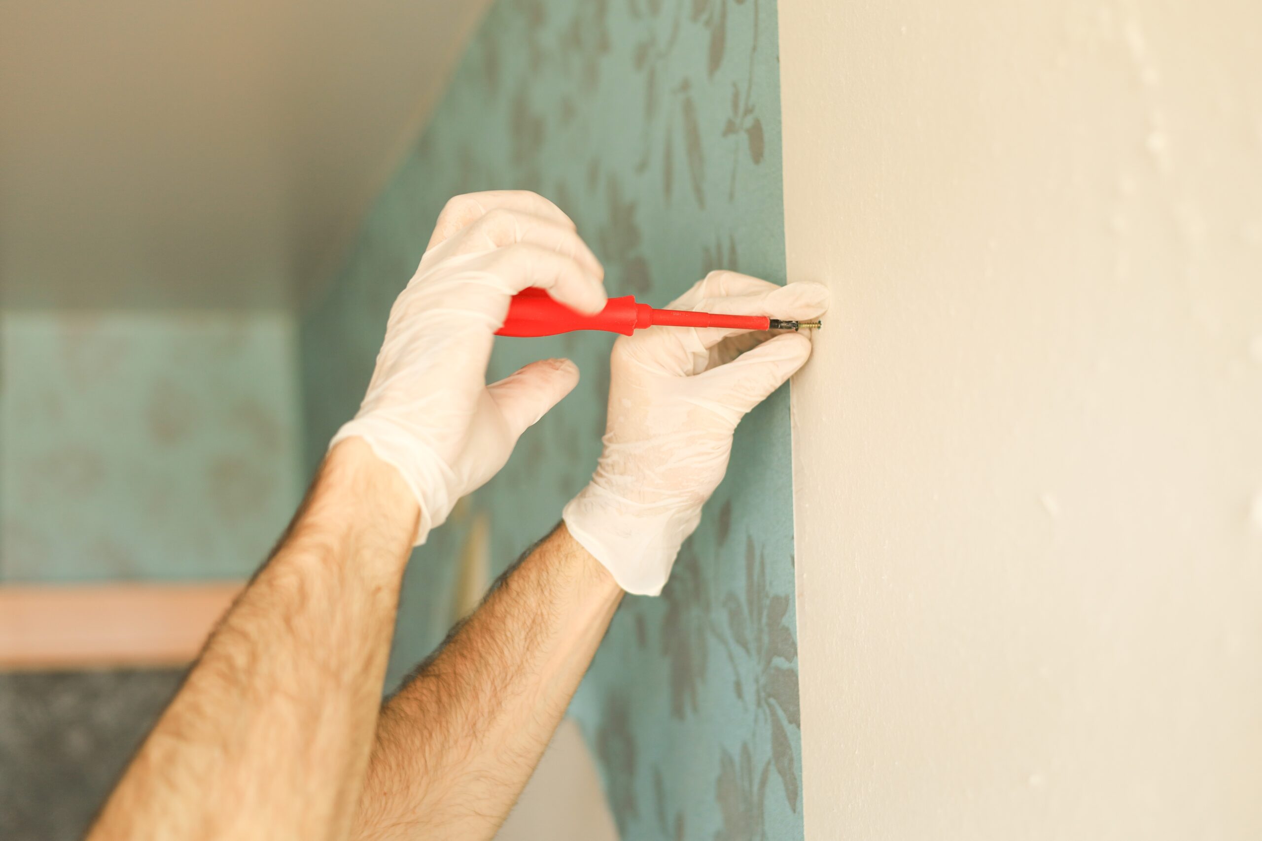 hands installing wallpaper in commercial building